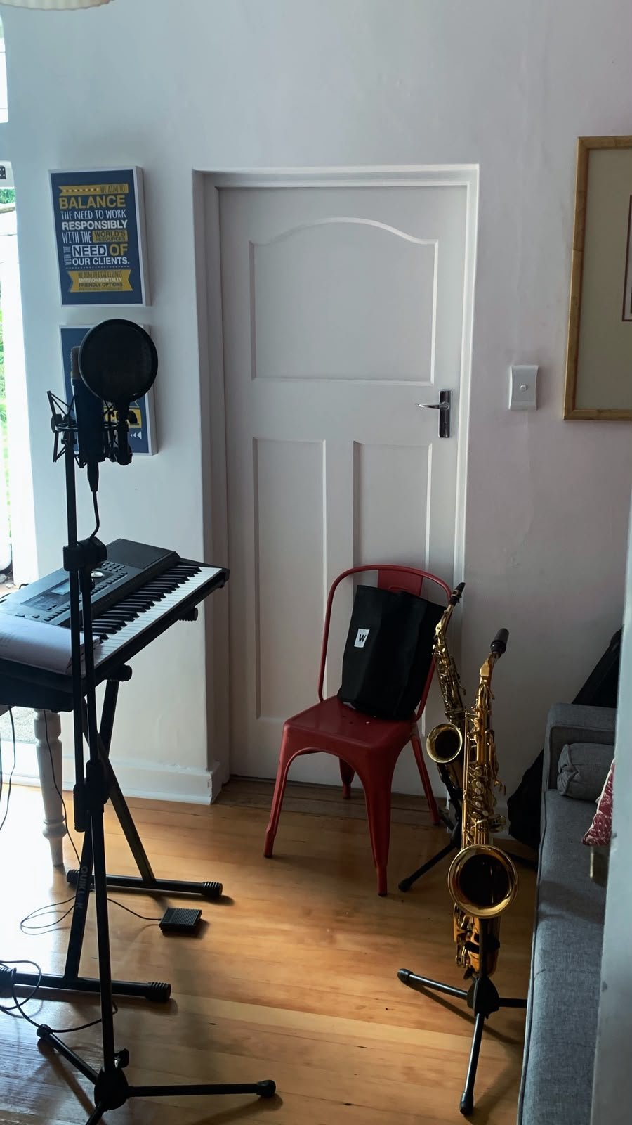 Sa'int Lucid's home studio with microphone, keyboard and saxophones